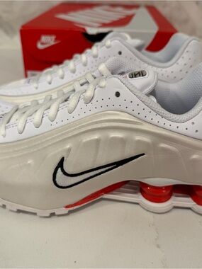 Nike White Sneakers with Black Swoosh and Red Accents